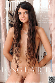 In the image of Greek goddesses, this teen poses in her bed and shows off her small breasts that she has under her long hair.