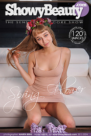 Charming teen cutie sexually poses with spring flowers and flashes her sweet tits and pussy